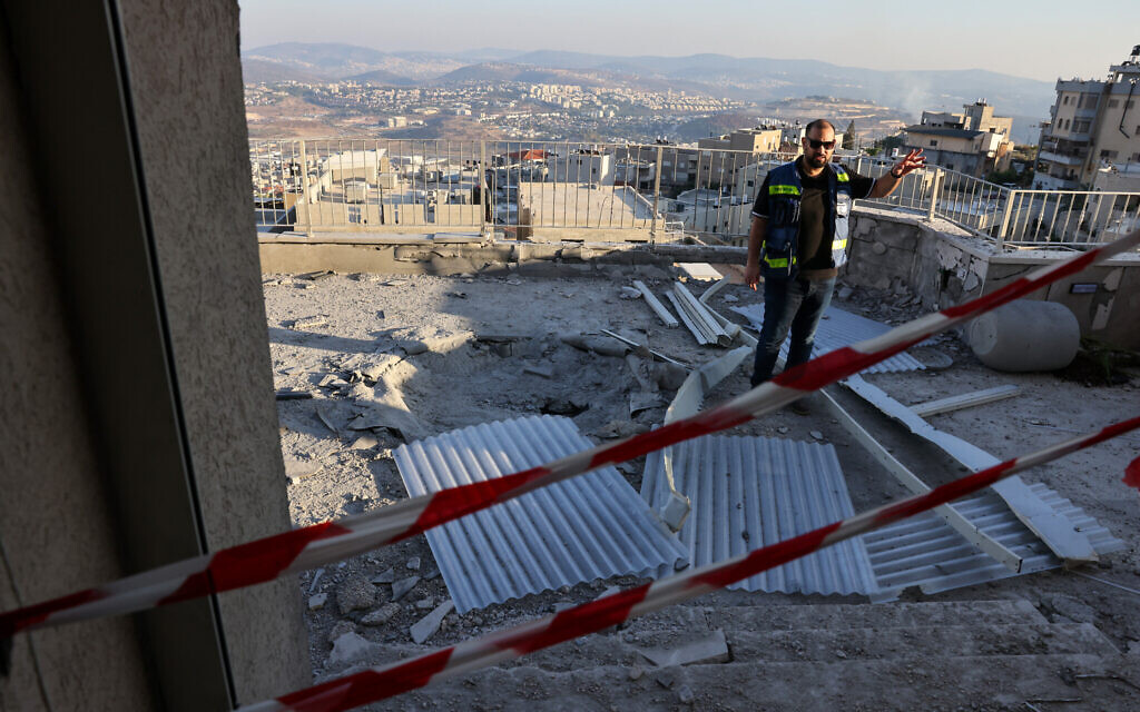 A man inspects the damage at a house hit during a rocket attack from southern Lebanon that targetted the northern Arab-Israeli village of Deir al-Asad on October 5, 2024. (Photo by AHMAD GHARABLI / AFP)